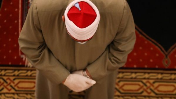 A Muslim cleric takes part in a morning prayer to celebrate the Eid al-Fitr holiday while wearing gloves and maintaining social distancing due to the COVID-19 pandemic, at Mohammed al-Amin Mosque in the Lebanese capital Beirut's downtown district on May 24, 2020. ANWAR AMRO / AFP