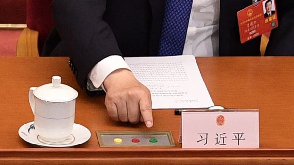Chinese President Xi Jinping votes on a proposal to draft a security law on Hong Kong during the closing session of the National People's Congress at the Great Hall of the People in Beijing on May 28, 2020. China's rubber-stamp parliament endorsed plans May 28 to impose a national security law on Hong Kong that critics say will destroy the city's autonomy. NICOLAS ASFOURI / AFP