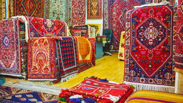 Watch the colorful Persian carpets in Vakil Bazaar of Shiraz, these are traditional goods and gifts from Iran (Shutterstock)
