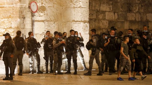 Israeli border guards stand at attention during the funeral of Iyad Hallak, a disabled Palestinian man who was shot dead by Israeli police after they mistakenly thought he was armed with a pistol, in Jerusalem late on May 31, 2020. Ahmad GHARABLI / AFP