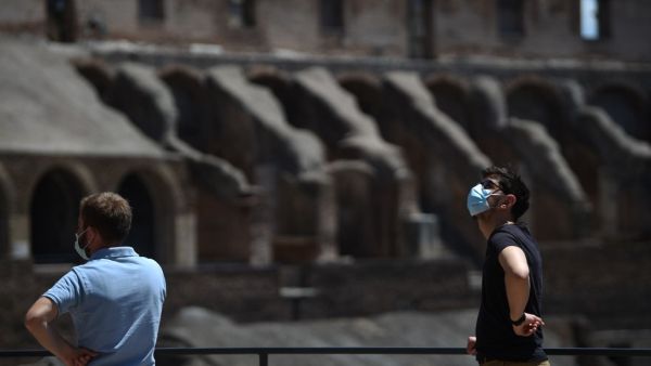 Visitors view the Colosseum monument which reopens to the public on June 1, 2020 in Rome, while the country eases its lockdown aimed at curbing the spread of the COVID-19 infection, caused by the novel coronavirus. The Colosseum monument reopens on June 1, 2020 after having been closed since March 8, 2020, with adequate sanitary protection for staff and visitors, secure routes, compulsory reservations and modified schedules to avoid crowds at peak times. Filippo MONTEFORTE / AFP