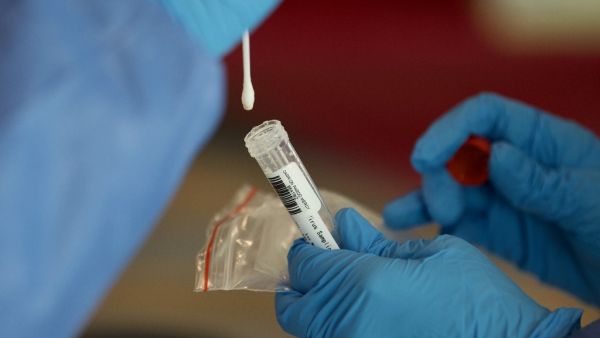 Health Ministry personnel test passengers for COVID-19 with PCR tests at Quito's International Airport as Ecuador resumes domestic flights amid the novel coronavirus pandemic, on June 1, 2020. (AFP)