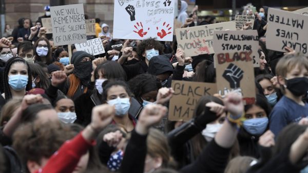 Demonstrators, some wearing a protective face mask, raise their fists during a protest in Strasbourg, eastern France, on June 5, 2020, in solidarity with protests raging across the United States over the death of George Floyd, an unarmed black man who died during an arrest on May 25. (FREDERICK FLORIN / AFP)