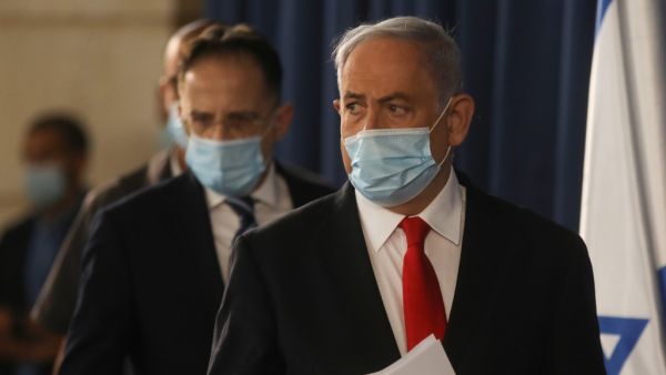 Israeli Prime Minister Benjamin Netanyahu arrives to the weekly cabinet meeting in Jerusalem on June 7, 2020. Netanyahu urged world powers to reimpose tough sanctions against Iran, vowing to curb Tehran's regional "aggression" hours after another deadly strike on pro-Iranian fighters in Syria. Menahem KAHANA / AFP