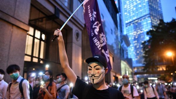 Pro-democracy protesters march in the Central district of Hong Kong on June 9, 2020, as the city marks the one-year anniversary since pro-democracy protests erupted following opposition to a bill allowing extraditions to mainland China. Anthony WALLACE / AFP