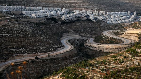 A serpentine road extends between the Jewish settlement of Givat Zeev (background) from Palestinian villages near the Israeli-occupied West Bank city of Ramallah, on June 10, 2020. Israel intends to annex West Bank settlements and the Jordan Valley, as proposed by US President Donald Trump, with initial steps slated to begin from July 1.  Ahmad GHARABLI / AFP