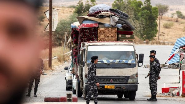 Members of security forces affiliated with the Libyan Government of National Accord (GNA)'s Interior Ministry stop a vehicle at a checkpoint in the town of Tarhuna, about 65 kilometres southeast of the capital Tripoli on June 11, 2020. Mahmud TURKIA / AFP