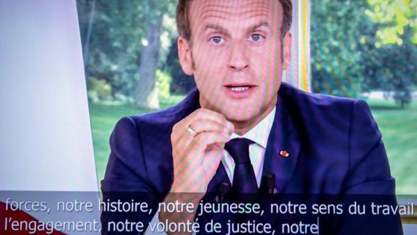 French President Emmanuel Macron is seen on a television screen in Paris on June 14, 2020 as he addresses the nation from the Elysee Palace during a televised speech, broadcast by French tv channel TF1. Thomas SAMSON / AFP
