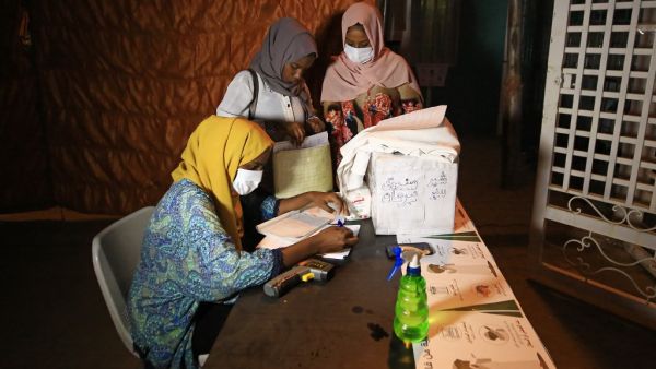 Volunteer pharmacists, wearing protective masks, work at a small treatment centre set up by locals in the Shambat district of northern Khartoum on June 18, 2020, amid acute shortage of medicine as Sudan fights to control the spread of COVID-19 coronavirus. As it battles mounting coronavirus cases, Sudan is grappling with acute scarcity of essential medications amid growing economic woes largely blamed on policies of ousted president Omar al-Bashir. Health care providers have recently reported pervasive shor