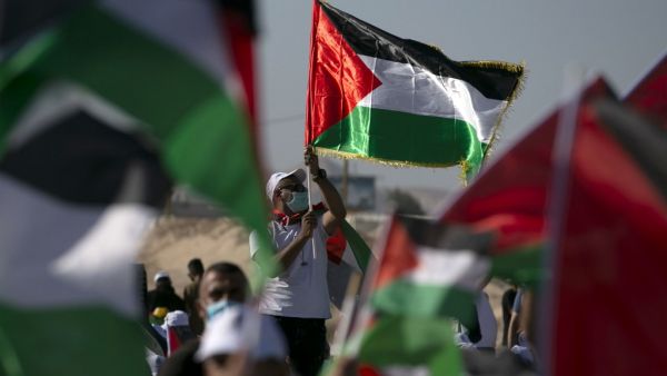 Palestinians wearing masks against the Covid-19 attend a big rally called by Palestinian Authority's Fatah party to protest against Israel's plan to annex parts of the occupied West Bank, in Jericho on June 22, 2020. Israel intends to annex West Bank settlements and the Jordan Valley, as proposed by US President Donald Trump, with initial steps slated to begin from July 1. ABBAS MOMANI / AFP