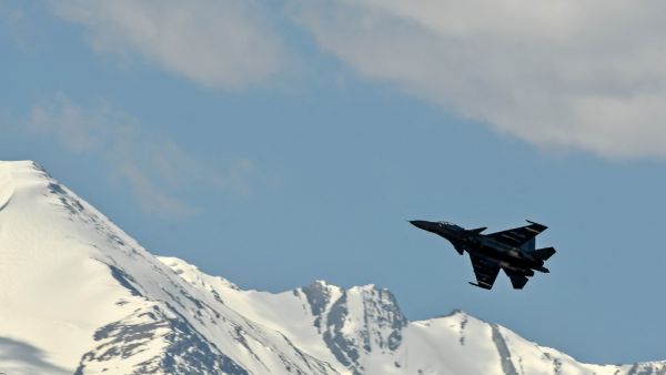 An Indian Air Force aircraft is seen against the backdrop of mountains surrounding Leh, the joint capital of the union territory of Ladakh, on June 27, 2020. India acknowledged for the first time on June 25 that it has matched China in massing troops at their contested Himalayan border region after a deadly clash this month. TAUSEEF MUSTAFA / AFP