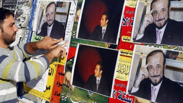 Above, pictures Rifaat Assad, right, the uncle of the Syrian president Bashar Assad, and Rifaat’s son Ribal are posted on a wall in Tripoli in this photo taken on December 6, 2007. (AFP)