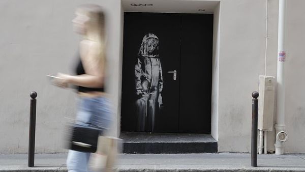 The artwork, which depicts a sorrowful girl in mourning, was cut out and snatched from the Bataclan concert hall in Paris in January 2019. it is shown above at the venue in 2018. (AFP)