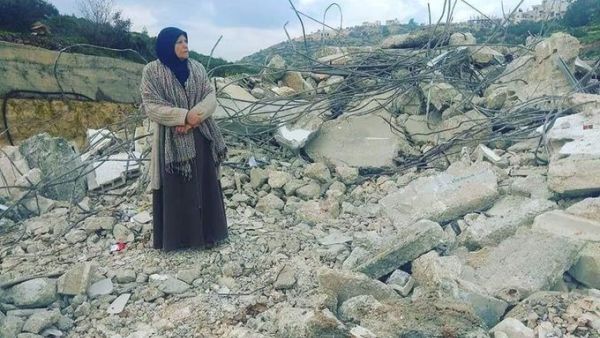 Mother of Palestinian_prisoner Asem al-Barghouti is standing on the rubble of his house which was demolished this night (Twitter)