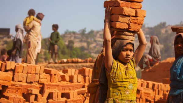 A young girl working in a brick factory  (Shutterstock)