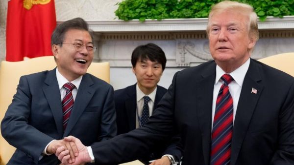 US President Donald Trump and South Korean President Moon Jae In shake hands during a meeting in the Oval Office of the White House. (AFP)