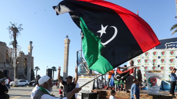 An elderly man waves a Libyan national flag during a demonstration in the Martyrs' Square in the centre of the Libyan capital Tripoli, currently held by the UN-recognised Government of National Accord (GNA), on June 21, 2020. The GNA on June 21 denounced Egypt's warning of military intervention in Libya, labelling it a "declaration of war", after the Egyptian President warned that if pro-GNA forces advanced on the strategic city of Sirte -- some 450 kilometres (280 miles) east of Tripoli -- it could provoke