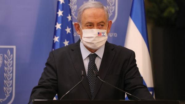 Israeli Prime Minister Benjamin Netanyahu wears a face mask against Covid-19, bearing the US and Israeli flags, during a press conference with US special representative for Iran at the prime minister's office in Jerusalem on June 30, 2020. ABIR SULTAN / POOL / AFP