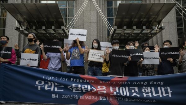 Protesters attend a rally against the release of the Disney movie 'Mulan' outside the company's office in Gangnam, in solidarity with Hong Kong's pro-democracy protests, in Seoul on July 1, 2020. Hong Kong police made the first arrest under Beijing's new national security law as the city greeted the anniversary of its handover to China with protests banned and its cherished freedoms looking increasingly fragile.  Ed JONES / AFP