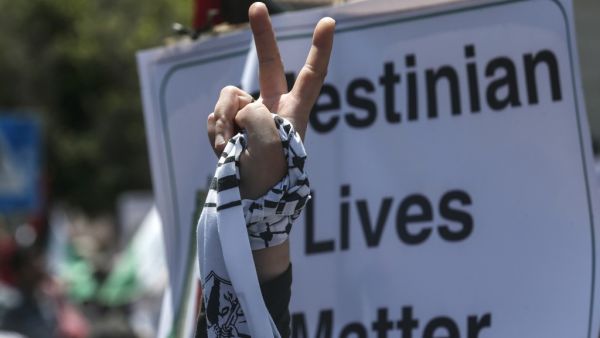 A Palestinian demonstrator flashes the victory sign during a rally as Palestinians call for a "Day of Rage" to protest Israel's plan to annex parts of the occupied West Bank, in Gaza City on July 1, 2020. Expectations of a major Israeli announcement on controversial annexations in the occupied West Bank dimmed, as global criticism of the project mounted and Palestinian protesters began gathering in Gaza. MAHMUD HAMS / AFP