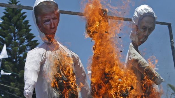 Palestinian supporters of al-Ahrar movement burn effigies depicting (L to R) US President Donald Trump, Trump's Middle East peace plan dubbed as the "Deal of the Century", and Israeli Prime Minister Benjamin Netanyahu, during a demonstration against Israel's plans to annex parts of the occupied West Bank, in Rafah in the southern Gaza Strip on July 7, 2020. Mohammed ABED / AFP