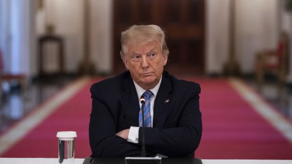 US President Donald Trump sits with his arms crossed during a roundtable discussion on the Safe Reopening of America’s Schools during the coronavirus pandemic, in the East Room of the White House on July 7, 2020, in Washington, DC. JIM WATSON / AFP