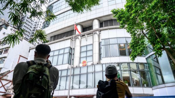Journalists take photos outside the Office for Safeguarding National Security of the Central People's Government in the Hong Kong Special Administrative Region after its official inauguration in Hong Kong on July 8, 2020. China opened a new office for its security agents to operate openly in Hong Kong for the first time under a tough new law, transforming a hotel into the force's headquarters. Anthony WALLACE / AFP