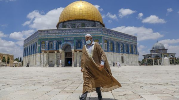 A Palestinian man walks outside the Dome of the Rock Mosque in Jerusalem's al-Aqsa compound amid the COVID-19 pandemic, on July 9, 2020. AHMAD GHARABLI / AFP