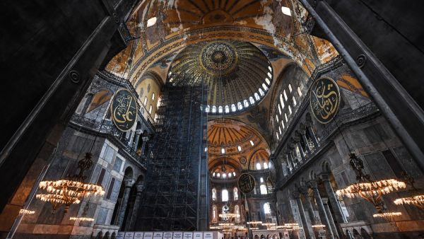 Tourists visit the inside of Hagia Sophia on July 10, 2020, in Istanbul, before a top Turkish court revoked the sixth-century Hagia Sophia's status as a museum, clearing the way for it to be turned back into a mosque. The Council of State, the country's highest administrative court which on July 2 debated a case brought by a Turkish NGO, cancelled a 1934 cabinet decision and ruled the UNESCO World Heritage site would be reopened to Muslim worshipping. The sixth-century Istanbul building -- a magnet for tour