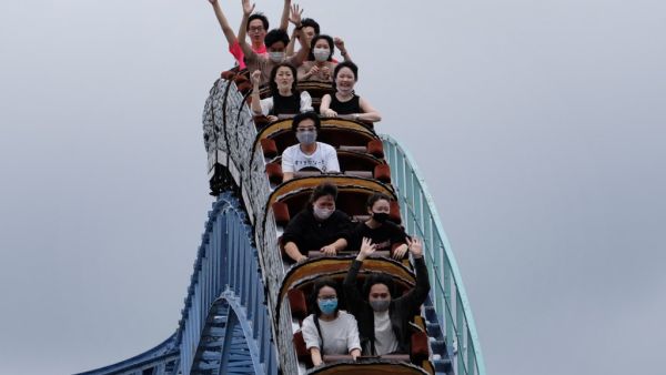 Visitors take a ride on a rollercoaster at the Toshimaen amusement park in Tokyo on July 13, 2020. Kazuhiro NOGI / AFP