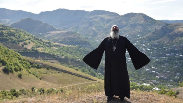Priest Ter Abel prays for peace outside the village of Movses on the Armenian-Azerbaijani border on July 15, 2020. Defence officials in Armenia and Azerbaijan said fighting on their border subsided on July 15, 2020 after several days of deadly clashes raised fears of a major flare-up. At least 16 people on both sides were killed in three days of shelling that started Sunday between the ex-Soviet republics, which have been locked for decades in a conflict over Azerbaijan's separatist region of Nagorny Karaba