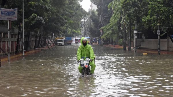 A man rides a bicycle through a water-logged street after a heavy downpour in Dhaka on July 21, 2020. The death toll from heavy monsoon rains across South Asia has climbed to nearly 200, officials said on July 19, as Bangladesh and Nepal warned that rising waters would bring further flooding. Munir Uz zaman / AFP