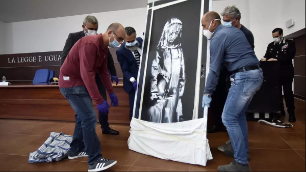 An artwork attributed to Banksy stolen from the Bataclan in Paris in 2019 was found in an abandoned Italian farmhouse. (AFP/File)
