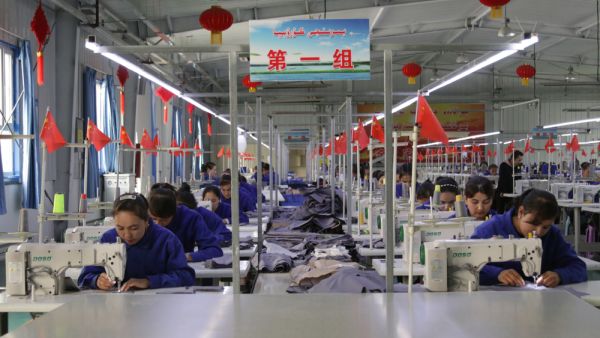 Uigur women work in a cloth factory in Hotan county, Xinjiang province, China. (Shutterstock/ File Photo)