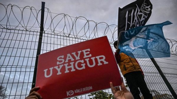 Protesters call on the international community to aid China’s Uighur Muslims outside the Chinese consulate in Istanbul on 13 December (AFP)