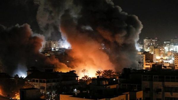 Fire and smoke around buildings in Gaza City during reported Israeli strikes on March 25, 2019. (Mahmud Hams / AFP)