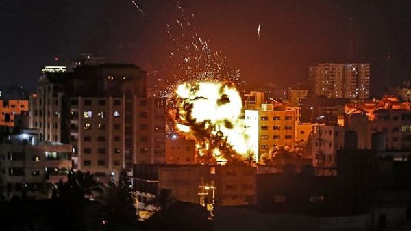 An explosion is seen among buildings during an Israeli airstrike on Gaza City in response to rocket fire from the Palestinian enclave on May 4, 2019. (Mahmud Hams/AFP)