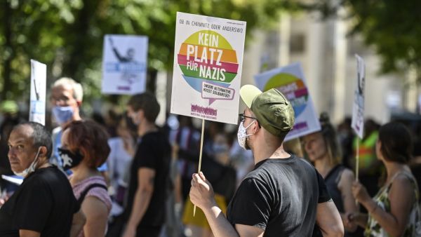 A counter-protester holds a sign reading "No place for Nazis" during a demonstration by the initiative "Querdenken-711" with the slogan "the end of the pandemic-the day of freedom" to protest against the current measurements to curb the COVID-19 spreading in Berlin, on August 1, 2020. John MACDOUGALL / AFP A counter-protester holds a sign reading "No place for Nazis" during a demonstration by the initiative "Querdenken-711" with the slogan "the end of the pandemic-the day of freedom" to protest against the current measurements to curb the COVID-19 spreading in Berlin, on August 1, 2020. John MACDOUGALL / AFP