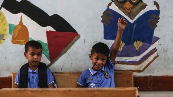 Palestinian students attend a class at a school run by the United Nations Relief and Works Agency (UNRWA) in Jabalia refugee camp in northern Gaza Strip, on the first day of school after local authorities eased some of the restrictions that were imposed in a bid to slow the spread of the novel coronavirus, on August 8, 2020. MAHMUD HAMS / AFP