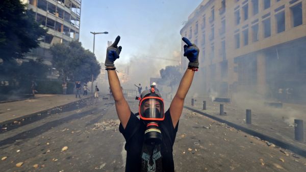 A Lebanese protester gives the middle finger to security forces during clashes in downtown Beirut on August 8, 2020, following a demonstration against a political leadership they blame for a monster explosion that killed more than 150 people and disfigured the capital Beirut. JOSEPH EID / AFP