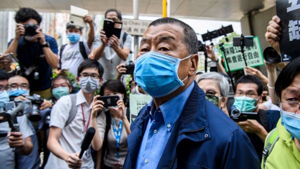 In this file photo taken on May 18, 2020, Hong Kong media tycoon and founder of the Apple Daily newspaper Jimmy Lai (C) arrives at the West Kowloon Magistrates Court for charges related to last year's protests in Hong Kong. Anthony WALLACE / AFP