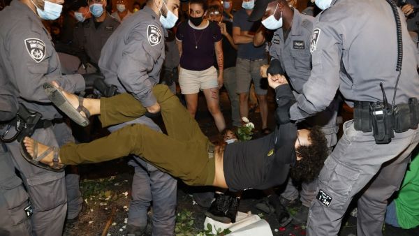 Police remove protesters blocking a main road during a demonstration against the Israeli government near the Prime Minister's residence in Jerusalem on August 16, 2020. JACK GUEZ / AFP