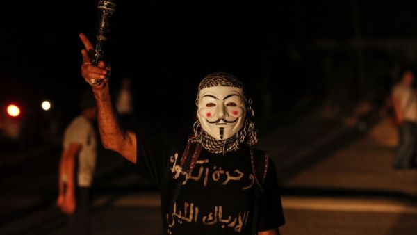 Palestinian protesters calling themselves the 'Night Confusion Units' gather near the Gaza-Israel border east of al-Bureij camp for Palestinian refugees in the central Gaza Strip on August 16, 2020. MAHMUD HAMS / AFP