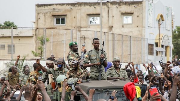 Armed members of the FAMA (Malian Armed Forces) are celebrated by the population as they parade at Independence Square in Bamako on August 18, 2020, after rebel troops seized Malian President Ibrahim Boubacar Keita and Prime Minister Boubou Cisse in a dramatic escalation of a months-long crisis. 