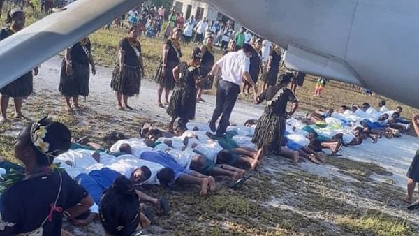 The grainy photograph that appeared on social media showed a man in a white shirt and grey trousers stepping on the backs of about 30 people lined up on the ground. (Twitter)