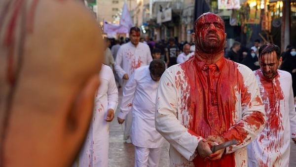 Iraqi Shiite Muslim worshippers are covered with blood after flagellating themselves during the mourning procession on the tenth day of Muharram which marks the day of Ashura, in the Iraqi holy city of Najaf (AFP)