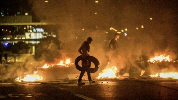 Demonstrators burn tyres during clashes with police in the Rosengard neighbourhood of Malmo, Sweden, on August 28, 2020. The protest was sparked by the burning of a coran by members of Danish far-right party Stram Kurs during an anti-Muslim rally in Malmo earlier in the day. The party's leader Rasmus Paludan, known for his anti-Muslim rhetoric, was due to attend the rally but he was arrested near Malmo and has been banned from Sweden for two years, authorities said on August 28. TT NEWS AGENCY / AFP