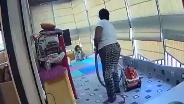 The maid swooped up the child in her arms when the massive explosion rocked their home. (Video Screenshot)