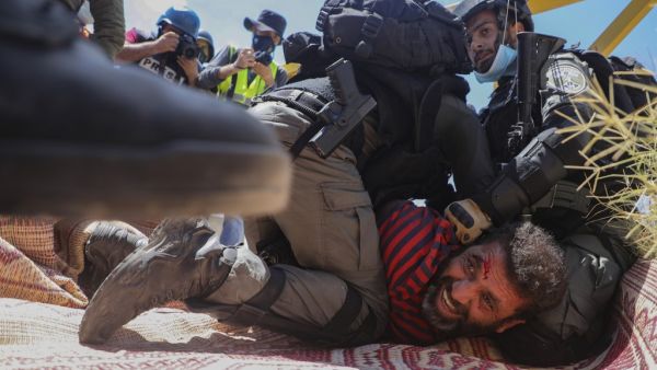Members of the Israeli security forces arrest a Palestinian demonstrator during a rally to protest against Israel's plan to annex parts of the occupied West Bank, in the village of Haris, southwest of Nablus, on August 21, 2020. JAAFAR ASHTIYEH / AFP