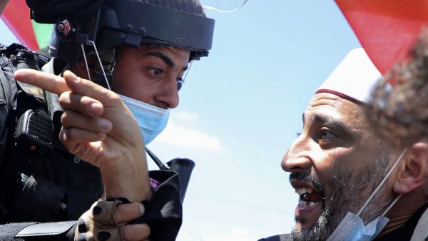 A Palestinian demonstrator argues with Israeli security forces during a rally to protest against Israel's plan to annex parts of the occupied West Bank, in the village of Haris, southwest of Nablus, on August 21, 2020. JAAFAR ASHTIYEH / AFP